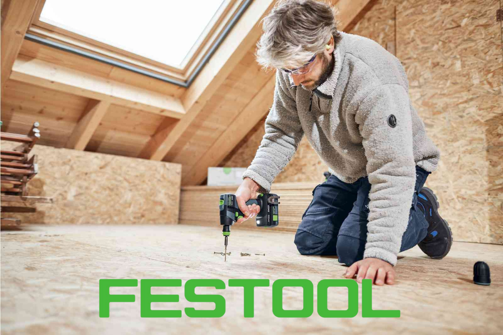 Male carpenter sawing a board with a circular saw in a carpentry workshop close-up